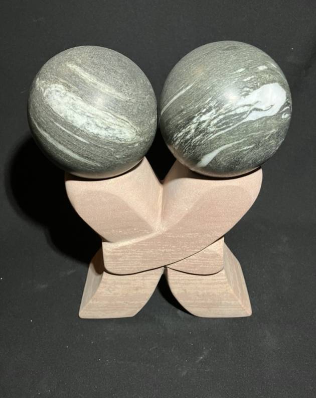 Kiss sculpture, sandstone with quartzite spheres